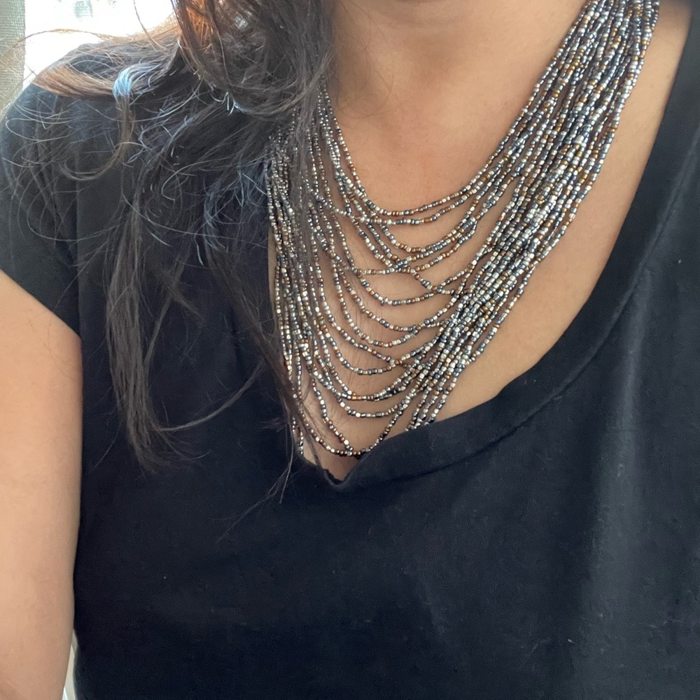 Handmade multi strand glass bead necklace in Silver, metallic blue, and bronze.